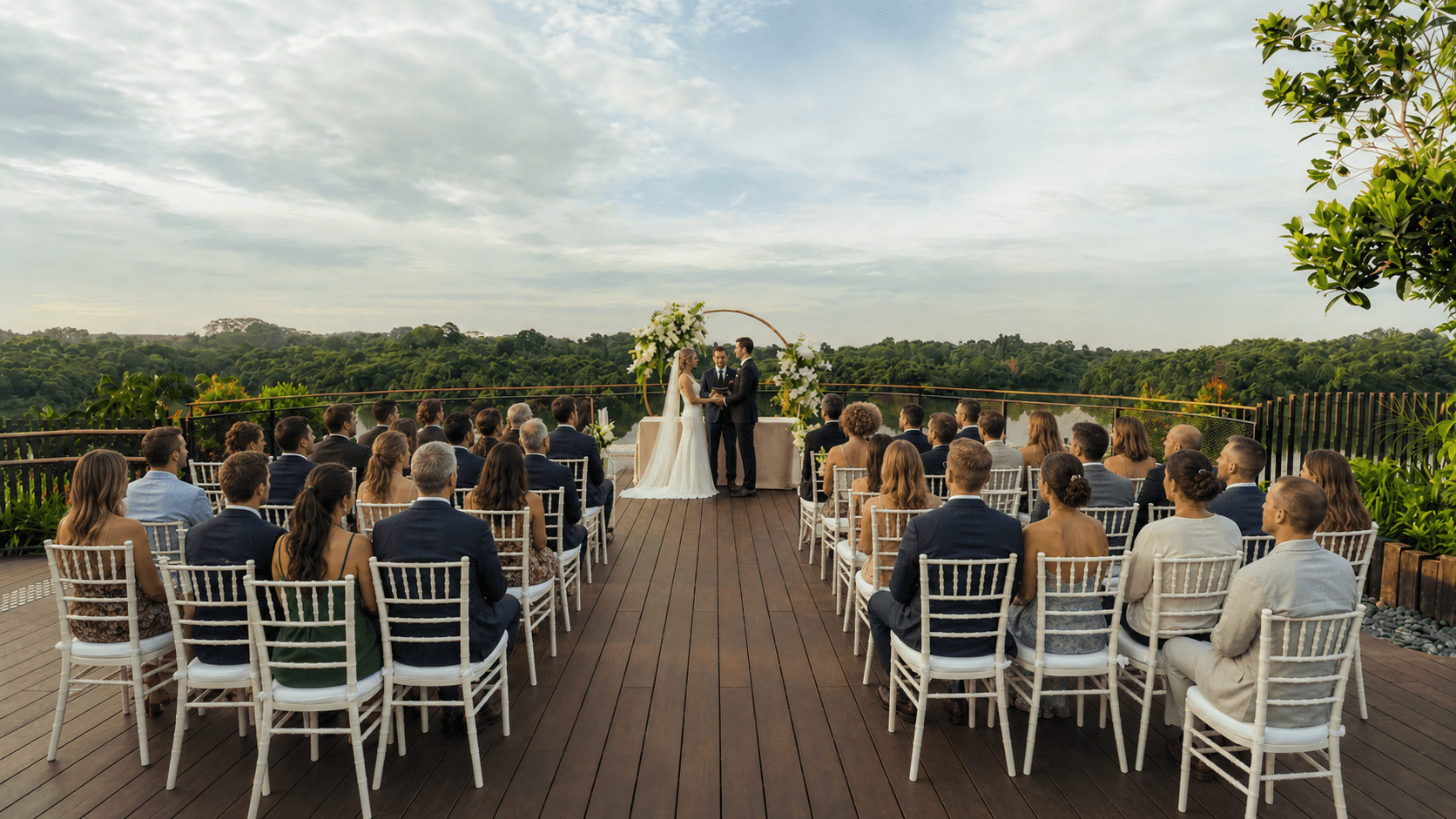 Wedding ceremony on a hotel terrace overlooking tropical landscape